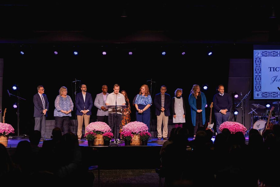 Award recipients stand on stage at Homecoming.