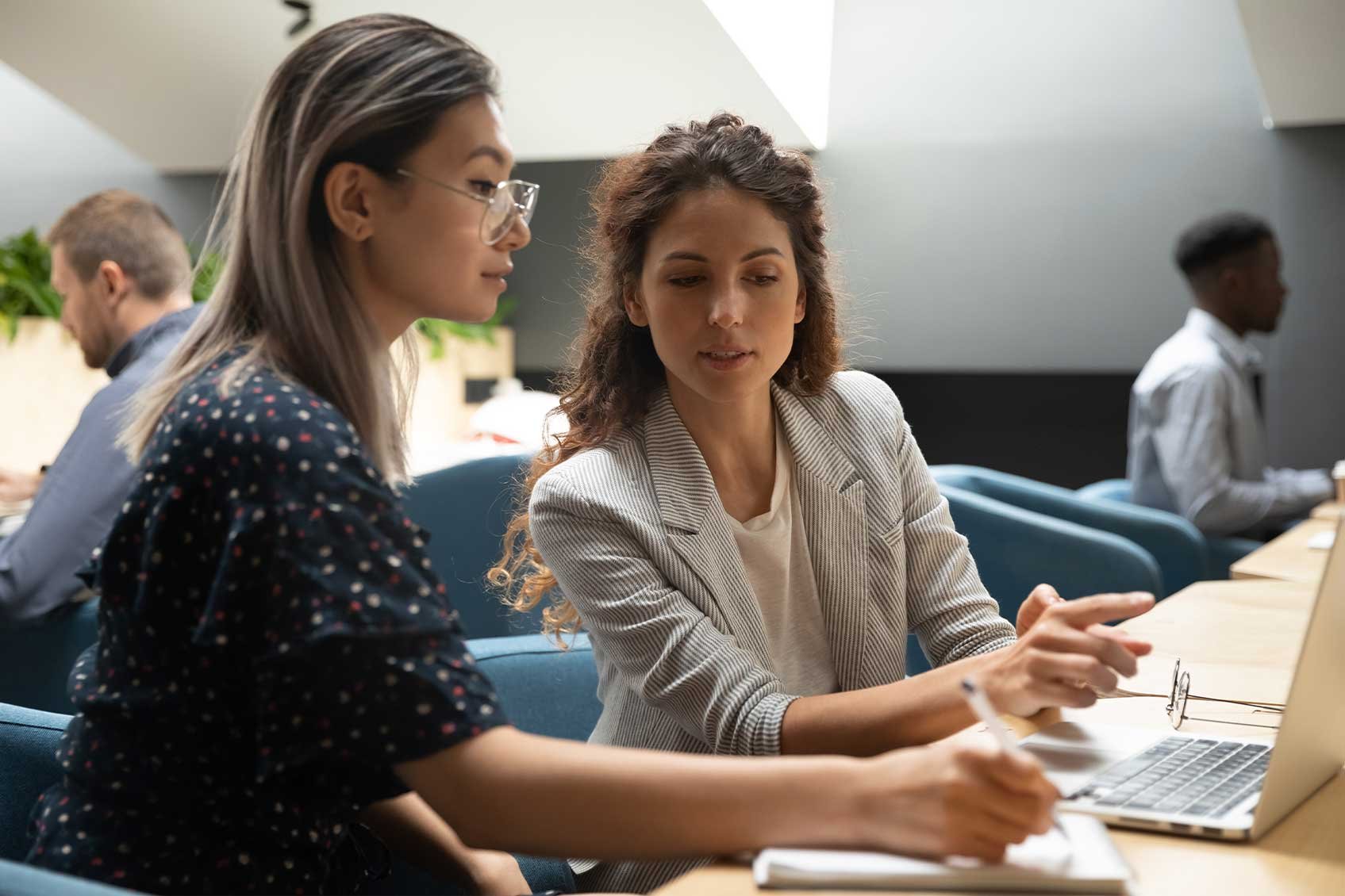 Two women collaborating with a laptop